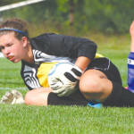 COVERING UP â€” Lake Region goalie Emily Bartlett secures the ball following a shot during last weekâ€™s soccer game against rival Fryeburg Academy. (Rivet Photo)