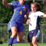 MAKING A MOVE â€” Lake Regionâ€™s Sydney Hancock (left) attempts to make a move past Fryeburg Academy defender Bri Pelkie. (Rivet Photo)